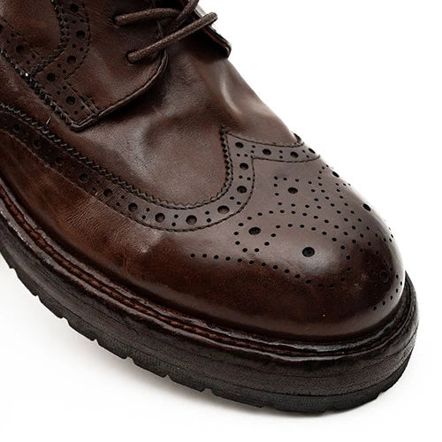 Brown wingtip brogue shoe with textured leather and a dark sole